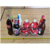 Image 1 : Pop bottles- some are full- coke and pepsi