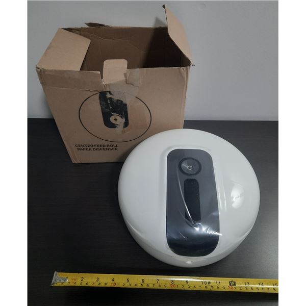 White wall-mounted center-feed roll paper dispenser featuring a central black panel for easy paper d