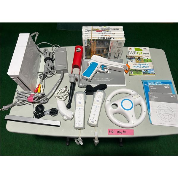 Wii gaming system with games, controllers, manuals.  Worked when last used.