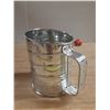 Image 5 : Vintage Bromwell's flour Sifter featuring a distinctive red wood knob on the hand crank.