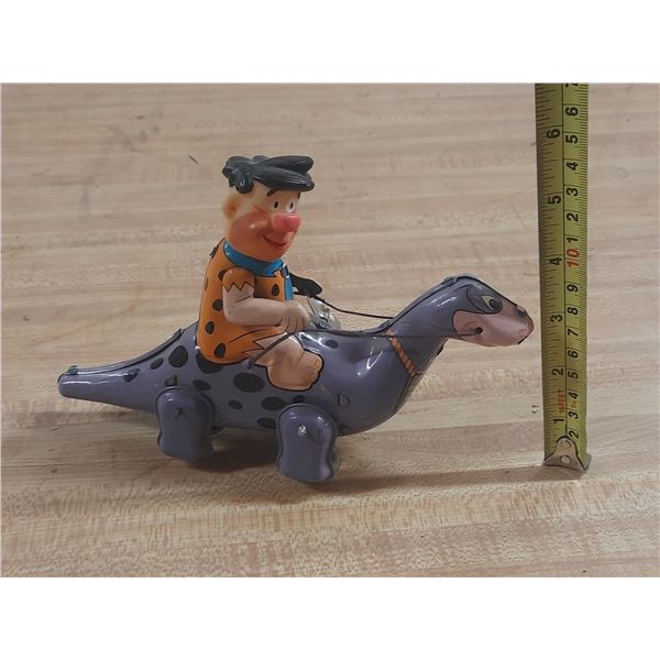 Vintage 1962 Louis Marx tin lithograph wind-up toy featuring Fred Flintstone riding Dino, originally