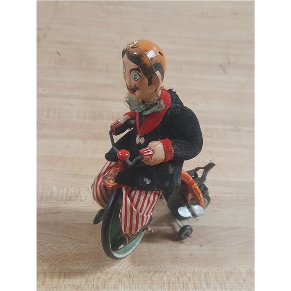 Vintage TPS Japan "Gay 90's" tin wind-up toy featuring a cyclist on a bicycle. (Untested)