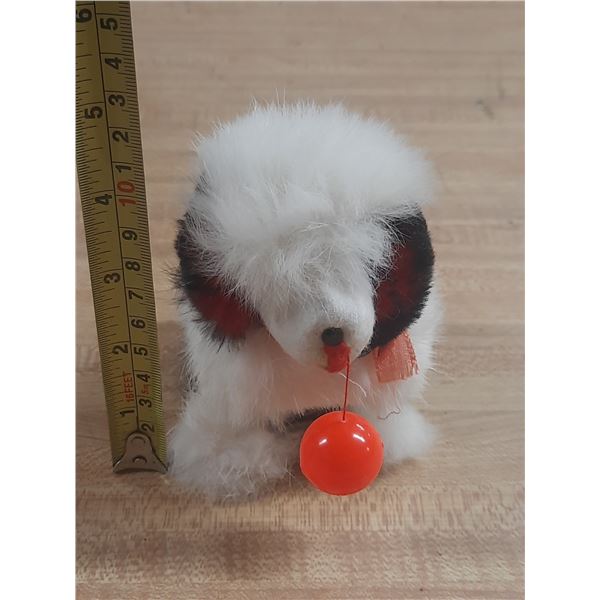 Vintage 1950s wind-up toy dog often referred to as a "Hoppity Doggy" or "Jumping Dog" made in Japan.