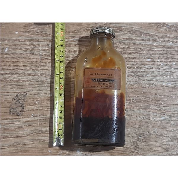 Vintage amber glass bottle labeled as "Raw Linseed Oil" from Ralph S. Fleury Chemist and Druggist in