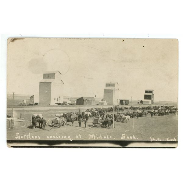 1910 RPPC – “Settlers Arriving at Midale, Sask.”  Posted.