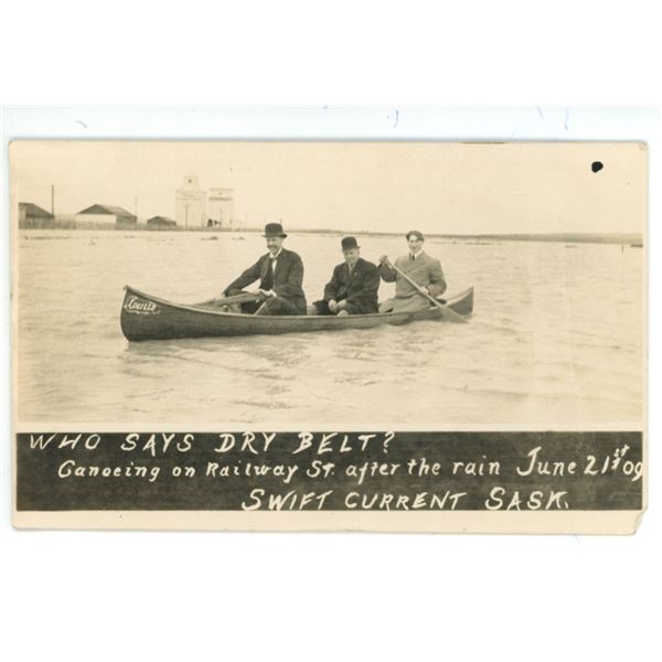 1909 RPPC – “Who Says Dry Belt?  Canoeing on Railway St. … June 21st [x=#