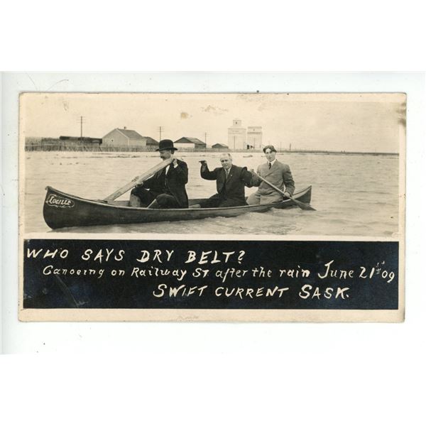 1909 RPPC – “Who Says Dry Belt?  Canoeing on Railway St. … June 21st [x=#