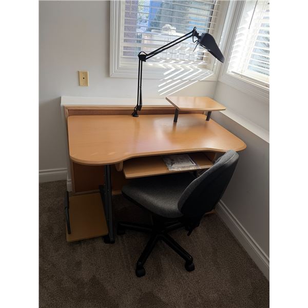 Desk and chair with clamp on lamp and cork board