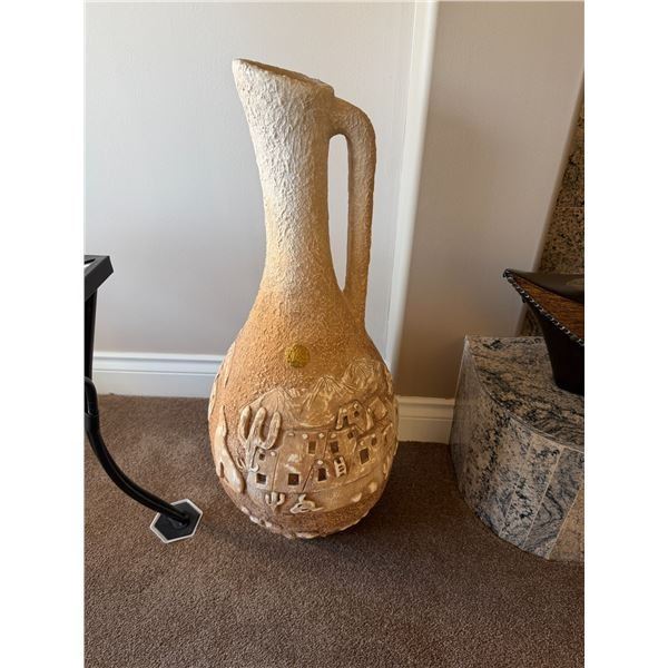 Southwest-style ceramic water jug vase featuring a textured desert scene with a handle. 32 inches ta