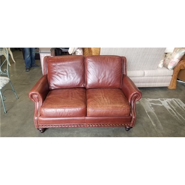 BROWN LEATHER LOVESEAT WITH BRASS NAILHEAD ACCENTS