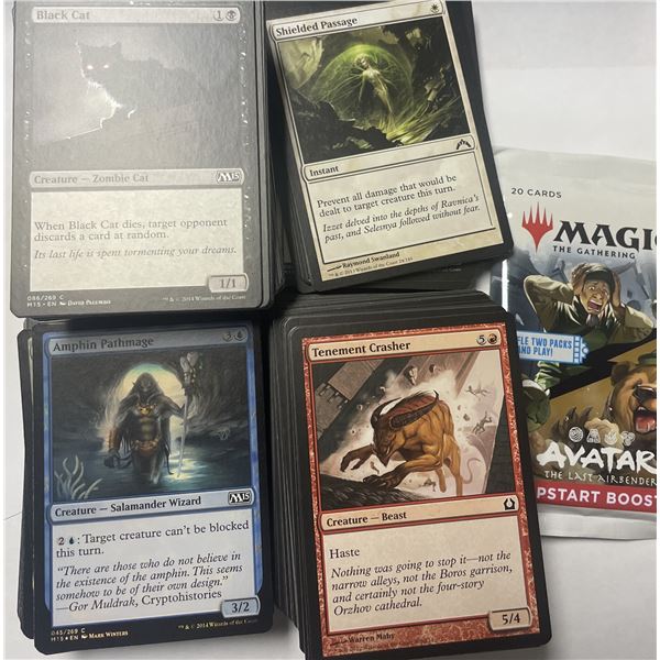 Magic: The Gathering trading cards featuring multiple stacks and a starter booster pack