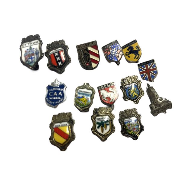 vintage enamel pins feature various European city and regional coat of arms
