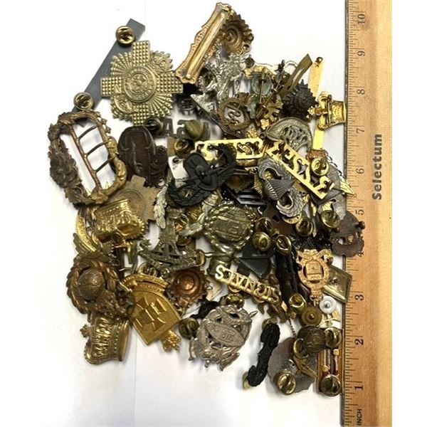 Canadian militaria, including various cap badges and sweetheart pins.
