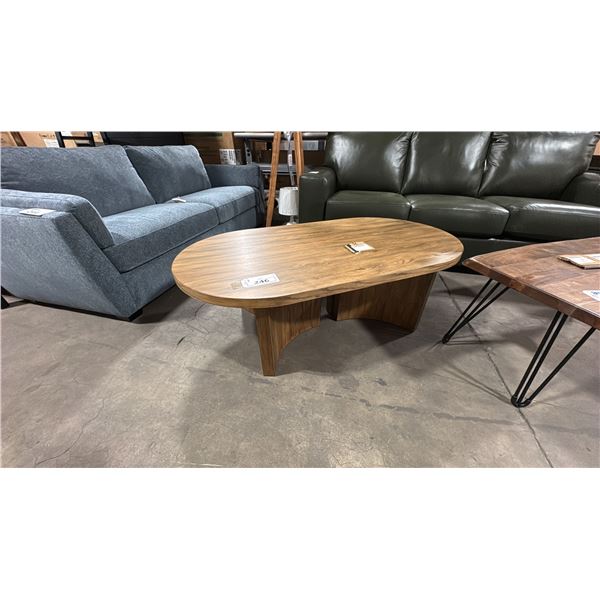 ASHLEY MODEL T683-0. AUSTANNY OVAL COCKTAIL TABLE. W52" D28" H17"