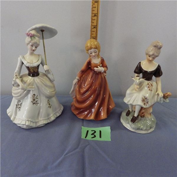 Center one is a vintage Royal Ascot figurine lady from the 1950s and two other figurine ladies
