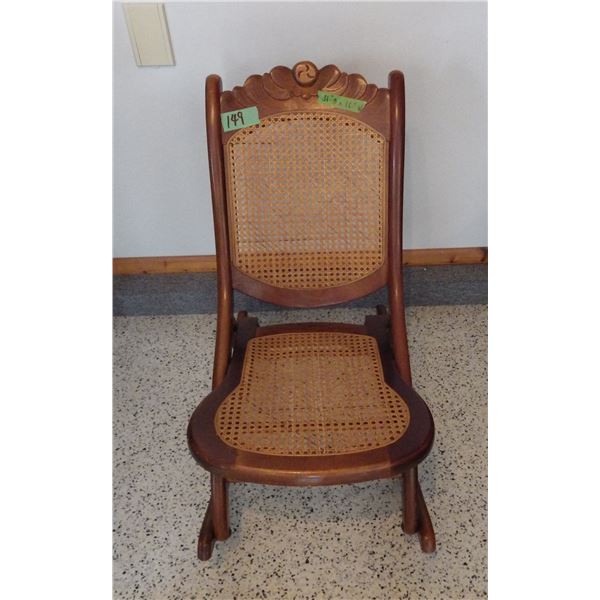 Vintage wood framed folding rocking chair with cane back and seat