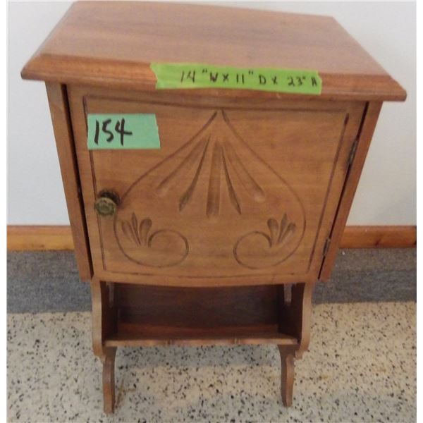 Small vintage table / stand with ornate carving on the door