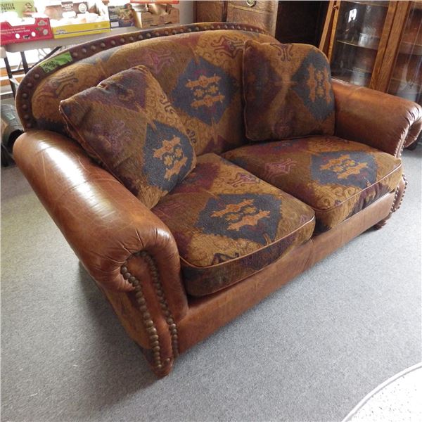 Love seat with leather style accents and upholstered seating