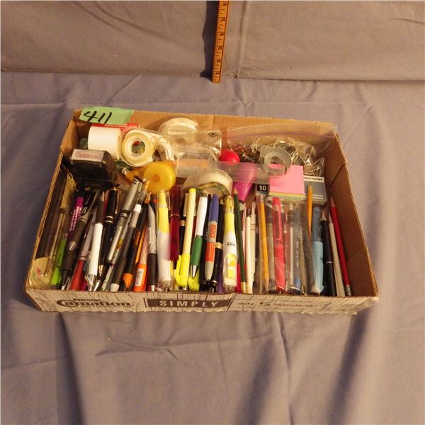 Box with assorted pens and tape