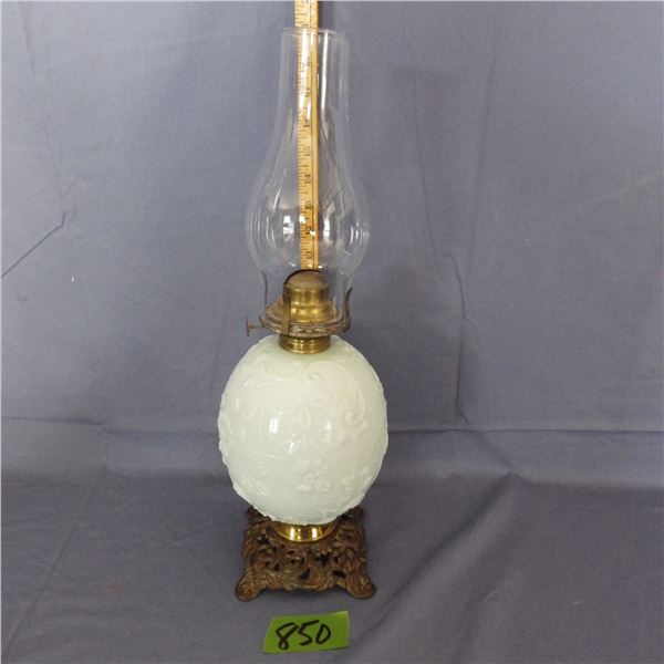 This oil lamp appears to be a fosteria spider web and pansy milk glass oil lamp With a decorative br