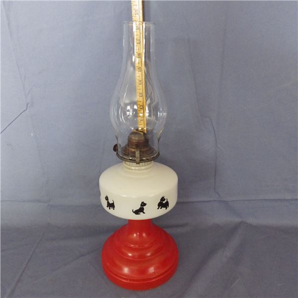 Vintage oil lamp with a red base and a Scottish Terrier dog pattern