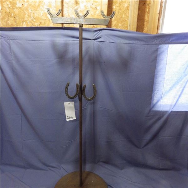 shop built stand for extension cords and miscellaneous with horseshoes used as the hangers