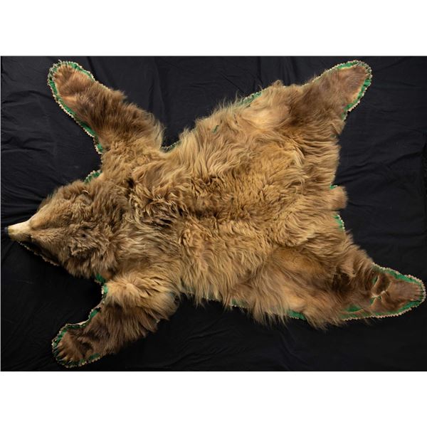 GRIZZLY BEAR RUG & MOUNTED BEAR SKULL.