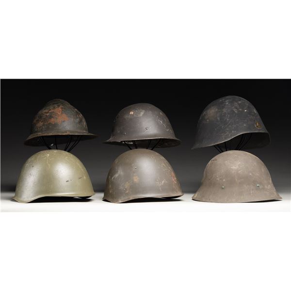 LOT OF FOREIGN MILITARY HELMETS.