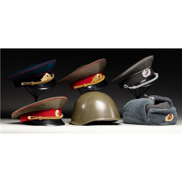 LOT OF ASSORTED SOVIET & EAST GERMAN HEAD GEAR.