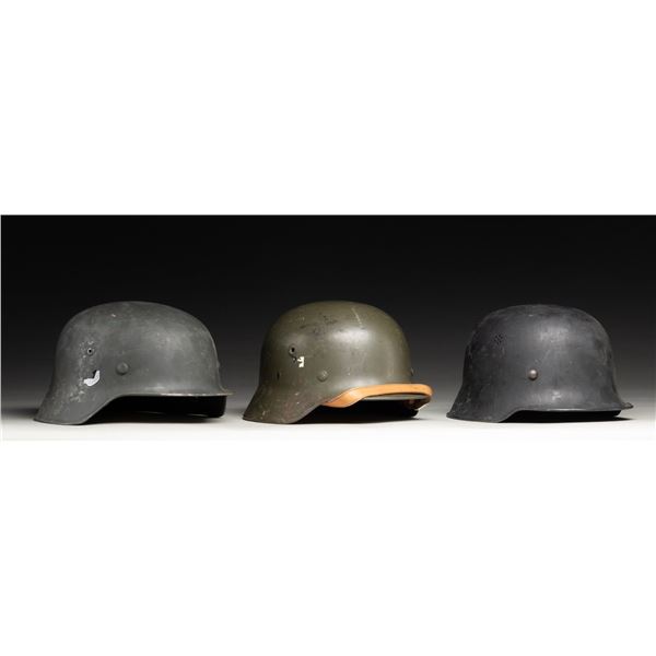 LOT OF 3 UNMARKED GERMAN STYLE HELMETS.