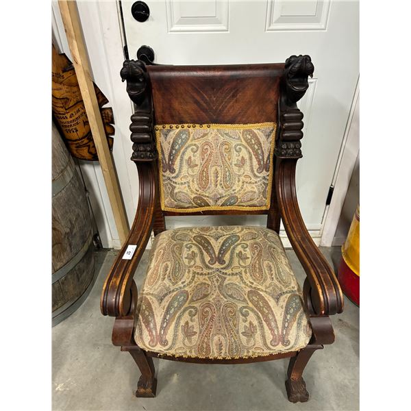 Vintage intricately carved wooden chair with lion heads