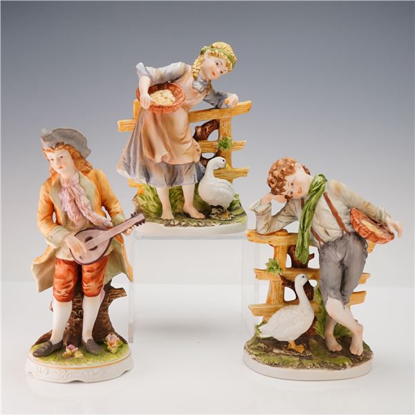 A Group of Three Polychrome Porcelain Figurines