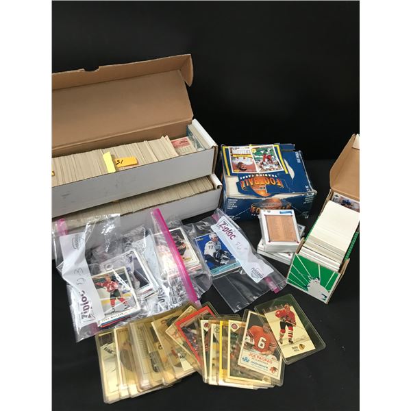 4 BOXES OF SPORTS TRADING CARDS AND SEVERAL SLEEVED CARDS
