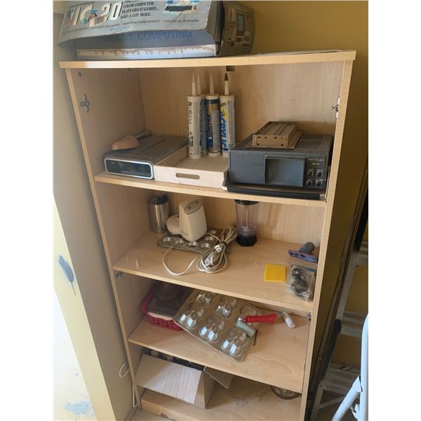 Wooden Shelving Unit with Mixed Household Items, Commodore VIC-20 Box, and Electronics