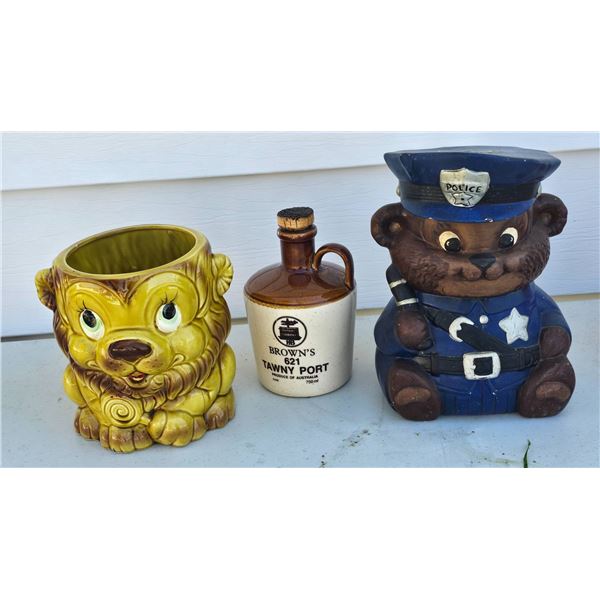 Three Ceramic Items: Police Bear Cookie Jar, Lion Planter, and Browns Port Jug