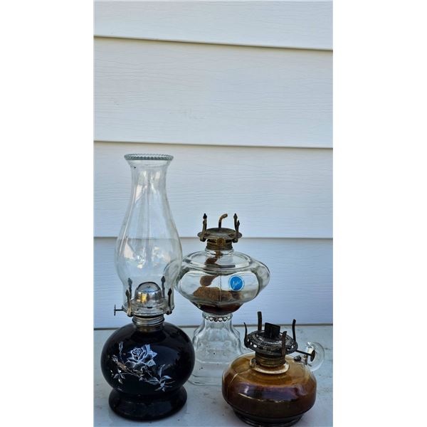 Three Glass Oil Lamps with Floral Motif and Decorative Accents