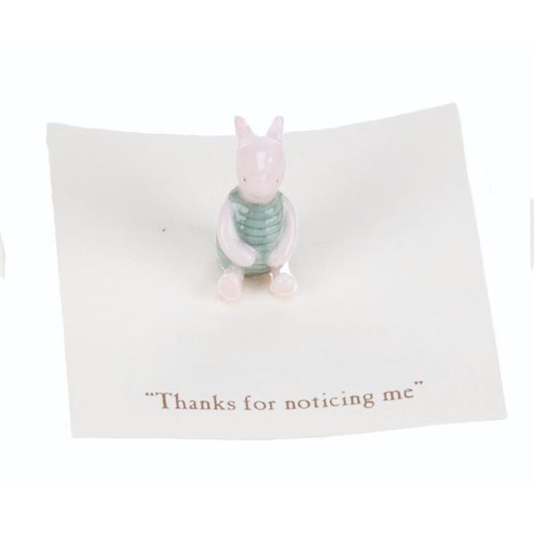 A Mini "Winnie the Pooh" Piglet Figurine.