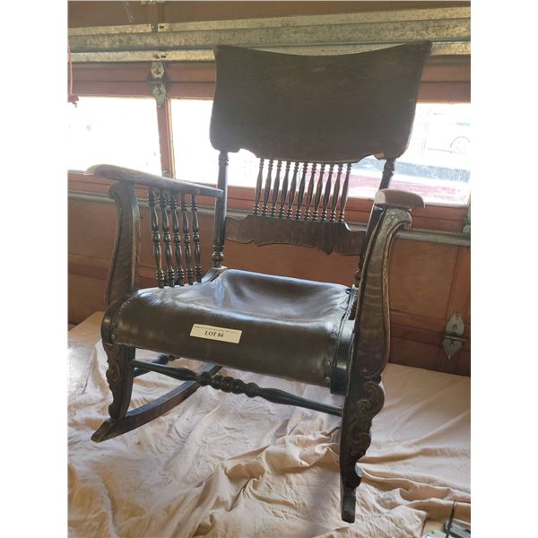 Antique Wooden Rocking Chair with Carved Details and Leather Seat