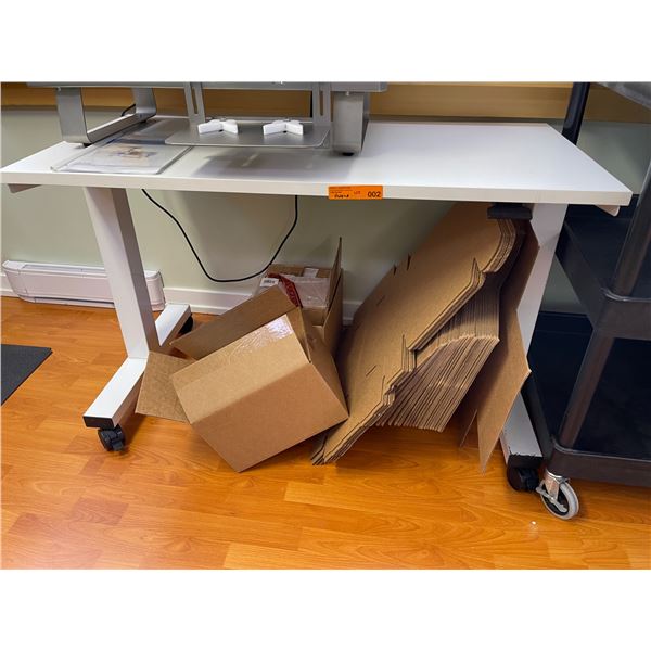 Height-Adjustable Work Table on Casters with Assorted Cardboard Boxes