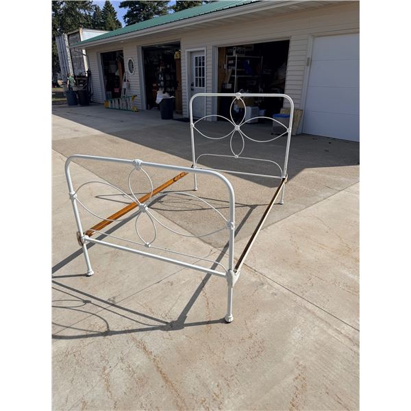 VINTAGE CAST IRON BED FRAME FEATURING A FLORAL MEDALLION DESIGN