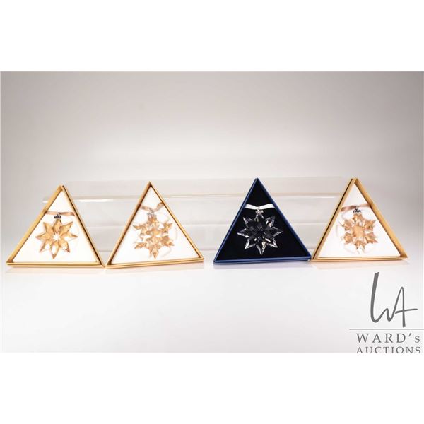 Four Swarovski Crystal collectible snowflakes including 2007, 2008, 20 Year 2011 and an SCS 2011