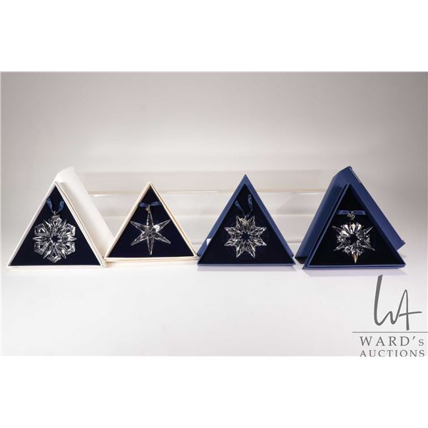 Four Swarovski Crystal collectible snowflakes including 1993, 1999, 2003 and 2007