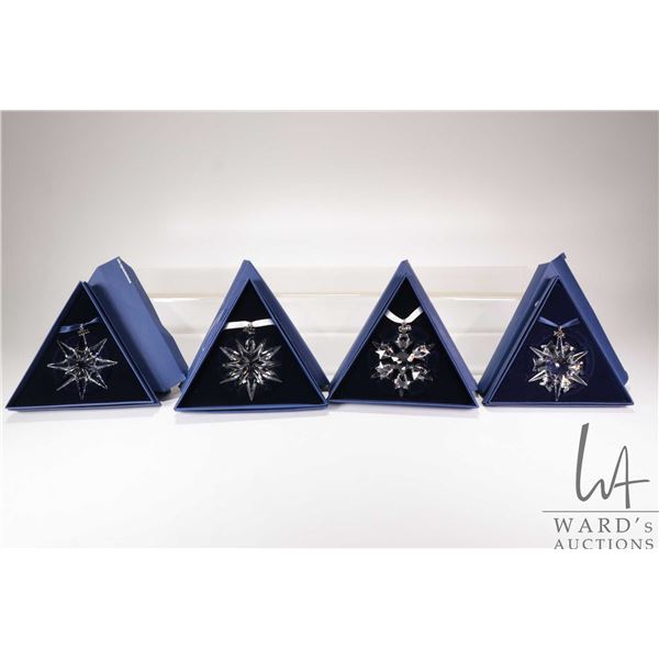 Four Swarovski Crystal collectible snowflakes including 1999, 2004, 2008 and SCS 2011