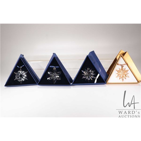 Four Swarovski Crystal collectible snowflakes including 2002, 2009, 2010 and 2011 20th anniversary