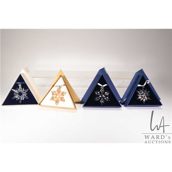 Four Swarovski Crystal collectible snowflakes including 1998, 2010 and 20th anniversary 2011 and SCS