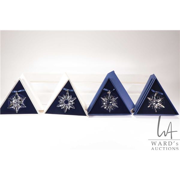 Four Swarovski Crystal collectible snowflakes including 1998, 2000, 2002 and 2006