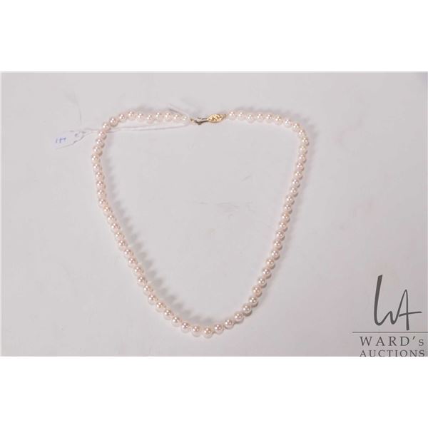Strand of individually knotted genuine pearls with 14kt gold clasp, 18" in length