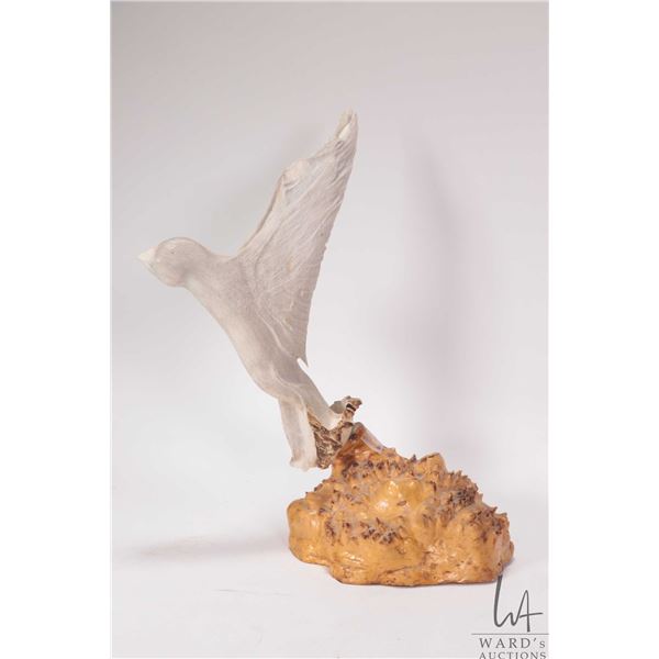 Carved antler bird in flight on burl wood base 12 1/2" in height