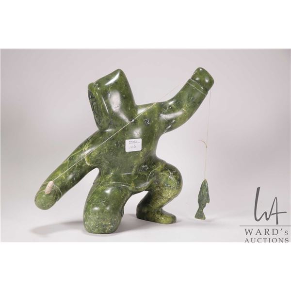 Inuit hand carved green serpentine carving of a fisherman with his catch, no artist signature seen, 