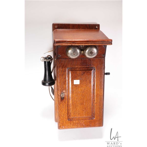Vintage unmarked oak cased wall phone, no battery